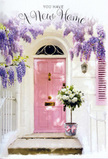 A softly lit East Dulwich front door is turned into a poetic still life, capturing all the anticipation and tenderness of a new home. The door is painted a calm, powder-pink, its smooth panels subtly reflecting a wash of natural light, while a narrow shutter in the same shade tucks neatly beside it against a clean, whitewashed wall. Above and around the frame, wisteria trails down in full, tumbling cascades of lavender and soft purple, each cluster hanging like a delicate chandelier and suggesting that unmistakable spring fragrance familiar to anyone walking towards Dulwich Village at blossom time. At the threshold, a generous floral arrangement sits in a simple grey metal bucket, its weathered look contrasting beautifully with the softness of the blooms. The bucket overflows with white and cream roses, their petals layered and plush, cupping into one another to form a billowing cloud of blooms. Gentle sprigs of fresh green foliage peek out from between the roses, adding a natural, garden-like touch that feels very at home in this leafy corner of south London. Around the base, a blush-pink ribbon is tied in a graceful bow, its satin surface catching the light and echoing the colour of the door. The overall atmosphere is warm, sheltered, and thoughtfully composed, like a housewarming surprise arriving from a trusted local florist. Every element-the dappled light, the trailing blossoms, the soft colours-combines to express congratulations, hope, and the kind of quiet joy that comes with stepping over a new threshold in East Dulwich.
